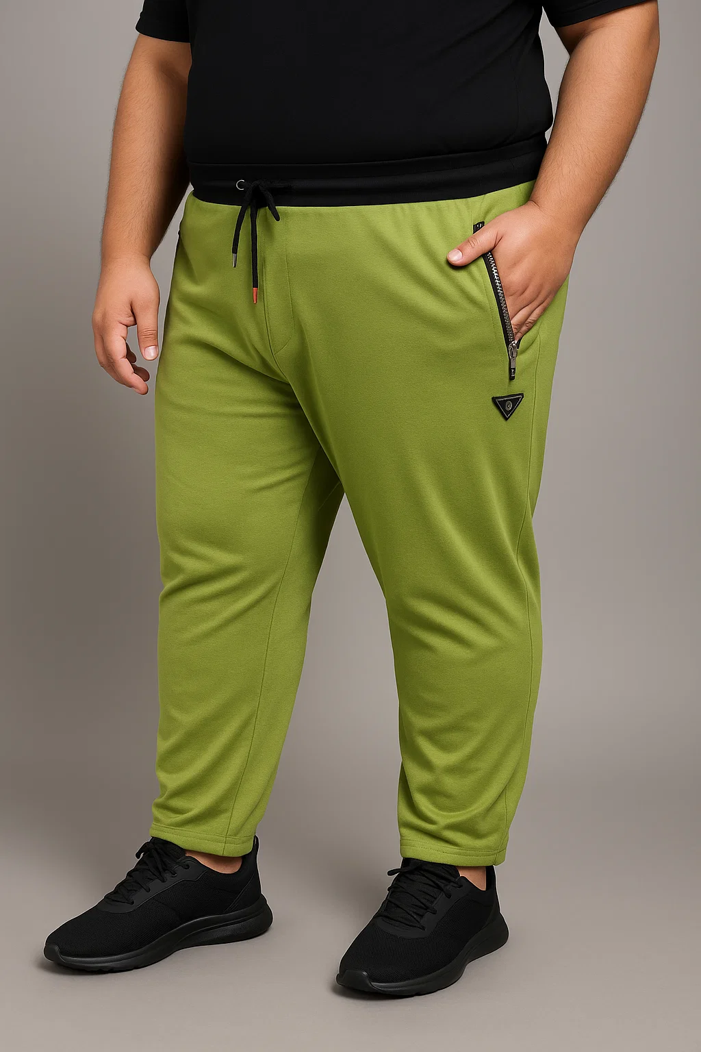 Green track pants with zip pockets and black waistband for men
